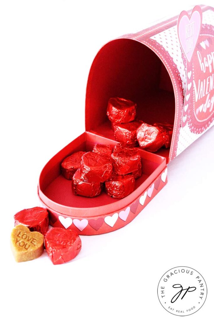 A pink, paper mailbox wholes wrapped candies showing the final result of this marzipan candy recipe.