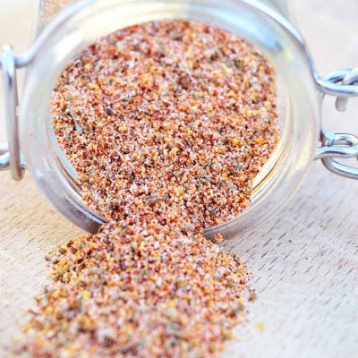 No salt seasoning falling out of a tipped over spice jar.