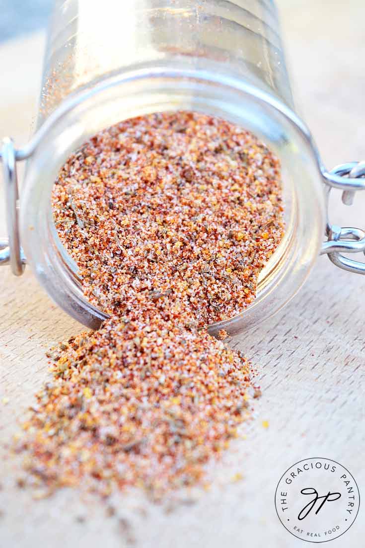 No salt seasoning falling out of a tipped over spice jar.