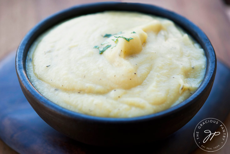 A black bowl filled with Potato Leek Soup Recipe