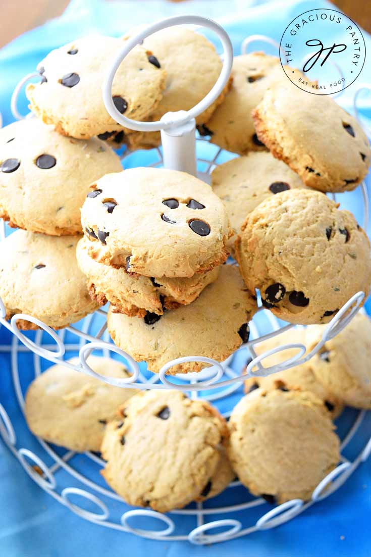 A close up shot of a two tiered platter holding Clean Eating Lavender Chocolate Chip Tea Biscuits. These yellowish white tea biscuits showcase the chocolate chips in them nicely.