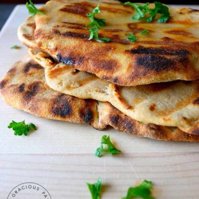 grilled flatbread stacked on cutting board
