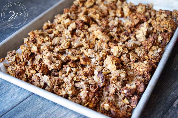A sheet pan filled with just-baked Clean Eating Low Sugar Granola, fresh out of the oven.