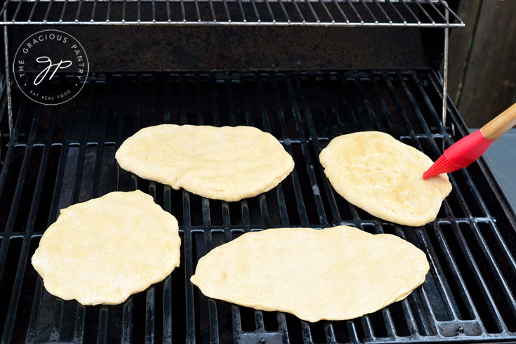 grilling homemade flatbread on a barbecue