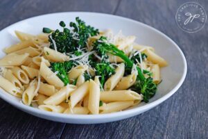 Horizontal shot of this garlicky broccolini pasta recipe served in a white bowl.