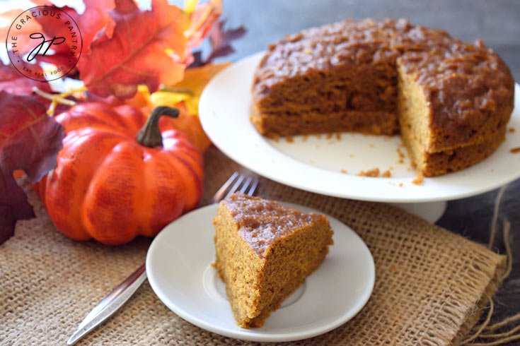 A slice of Pressure Cooker Pumpkin Spice Cake on a white plate.