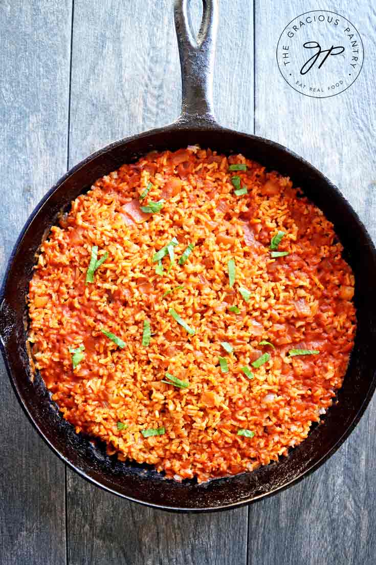 An overhead view looking down into a black skillet filled with this just-cooked, Clean Eating Salsa Rice.