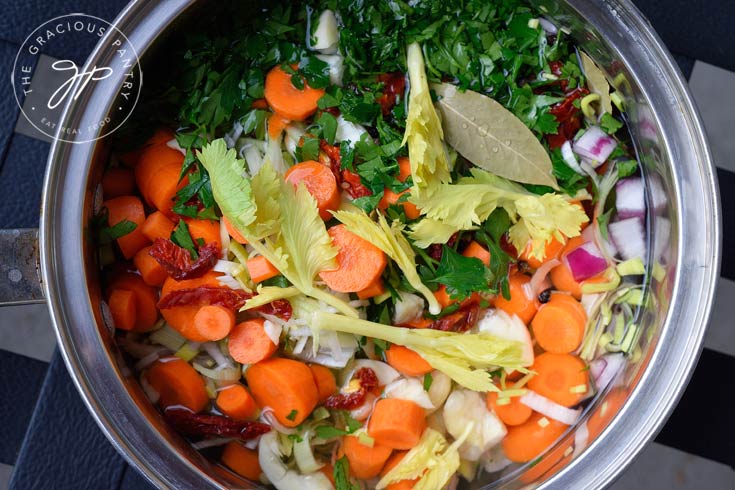 A beautiful mixture of vegetables sit in a pot, ready to go on the stove to make this Clean Eating Vegetable Stock.