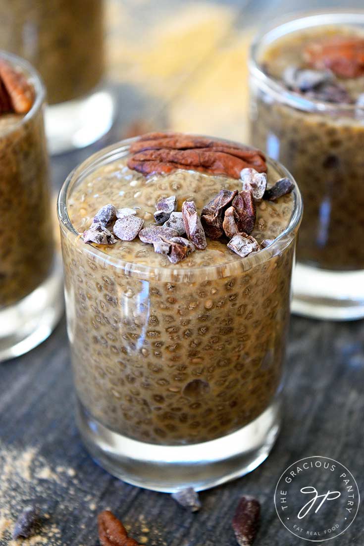 A single, clear shooter glass sits filled with this Clean Eating Maca Chia Seed Pudding. It's an up-close view of a single shooter.