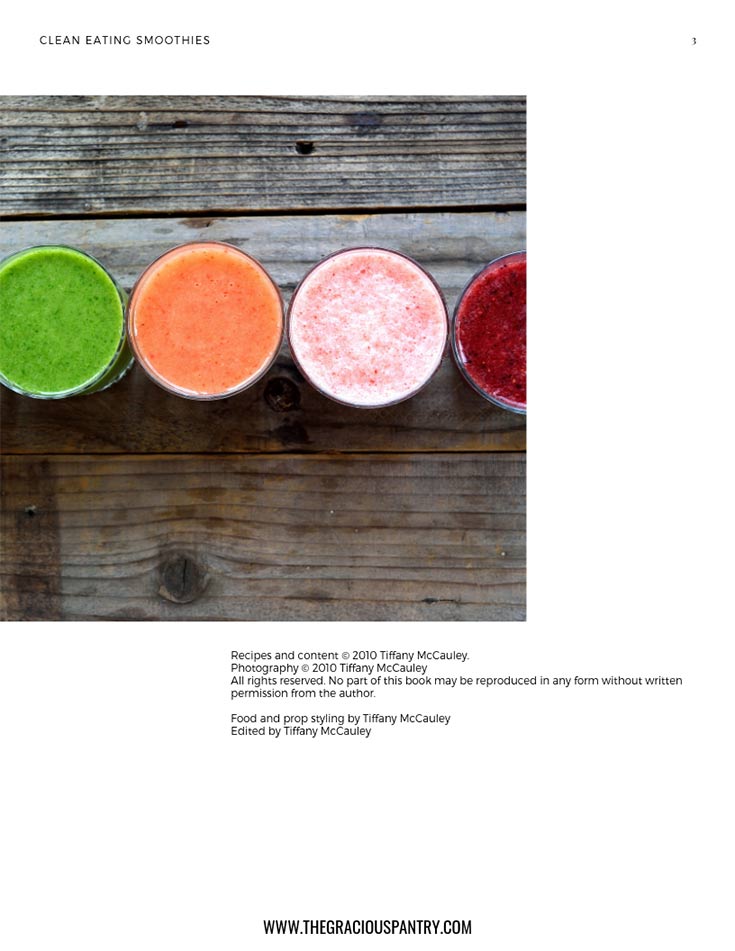 A view of the inside credit page in this Clean Eating Smoothies eCookbook. It shows blended smoothies of different colors sitting in a row on a wooden table.