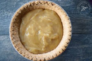 Step 1 of building this clean eating banana cream pie shows the custard in the pie crust.