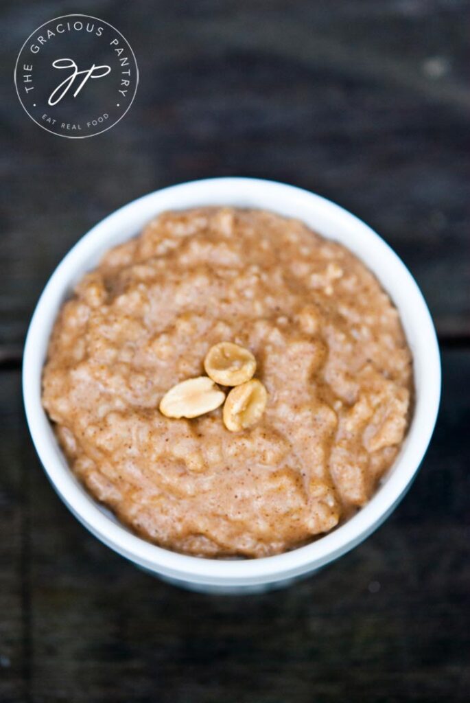 Peanut Butter Oatmeal from overhead, served in a white bowl, sitting on a gray background.
