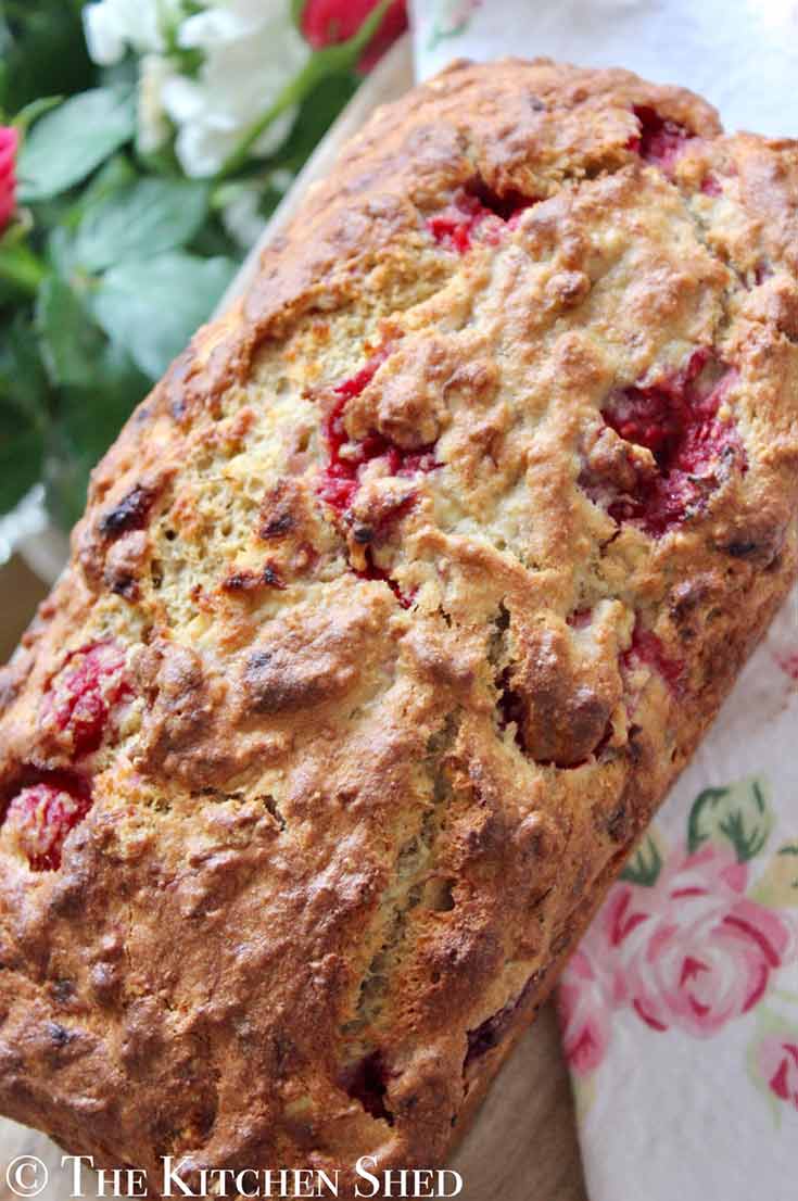 An overhead view of a full, uncut loaf of this Clean Eating Raspberry Vanilla Banana Bread.