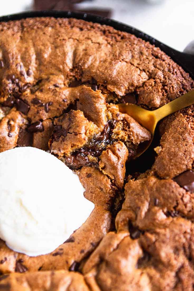 And up close view of this Clean Eating Skillet Chocolate Chip Cookie with a single scoop of vanilla ice cream in the middle.