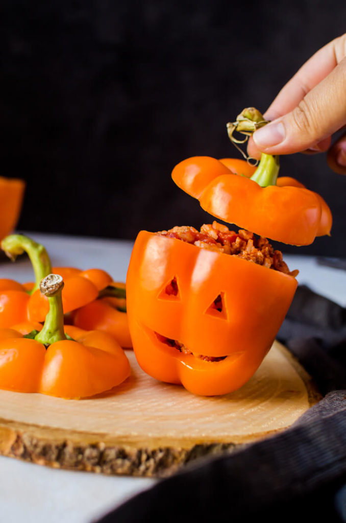 Halloween stuffed peppers carved like Jack O Lanterns