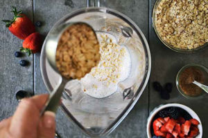 Adding oats to the blender.