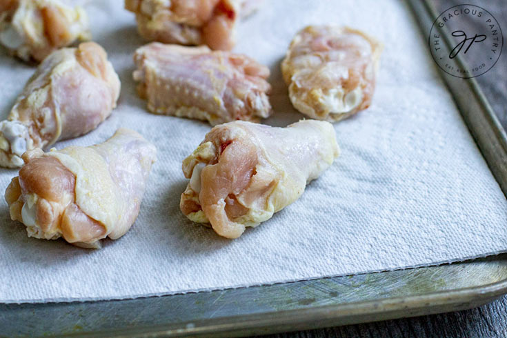 Step one of this Air Fryer Chicken Wings Recipe shows the wingettes on the pan.
