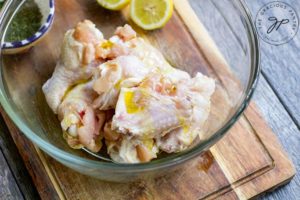 Step two of this Air Fryer Chicken Wings Recipe shows the chicken in a bowl, ready to mix with spices.