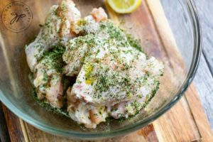 Step 3 of this Air Fryer Chicken Wings Recipe shows the spices being added to the bowl of chicken wings.