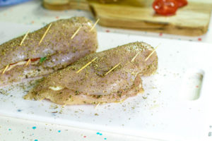 The last step before cooking this Air Fryer Chicken Breasts Recipe is to close up the butterflied chicken breast and hold in place with toothpicks.