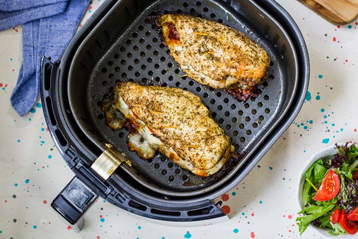 Air Fryer Chicken Breast, just finished cooking and sitting in the air fryer basket.