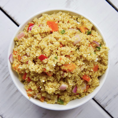 An overhead shot looking down into a white bowl filled with this Clean Eating Mediterranean Quinoa Salad.