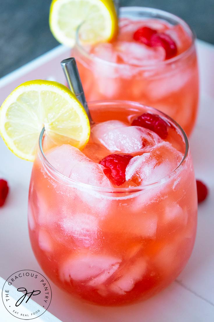 A closeup view of the glasses of raspberry lemonade, focusing on the glass in front.