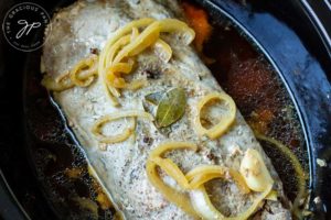 Step four shows the pork loin cooked and still in the slow cooker with the lid off.