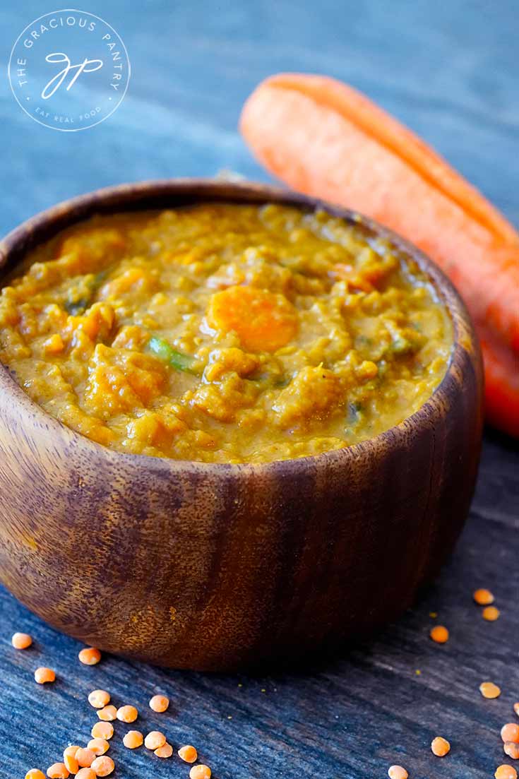 A delicious bowl of this Sweet Potato Curry Recipe shows a wooden bowl filled with curry, ready to eat.