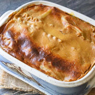 This Butternut Squash Lasagna sits, uncut, in it's casserole dish, freshly out of the oven.