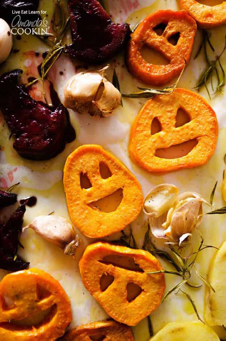 Roasted Halloween vegetables in the shape of pumpkins.