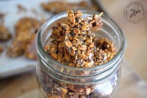 An open jar filled with pumpkin spice granola bark.