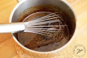 Step 2 of this Pumpkin Spice Granola Bark Recipe is to combine the syrup and sugar and bring to a boil. Then remove from heat.