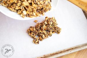 Step 7 is to transfer the oats to a parchment-lined baking pan.