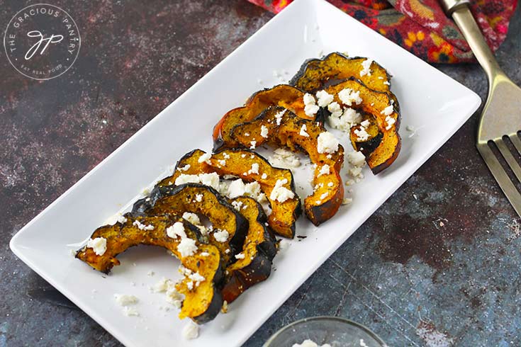 The final step in this Roasted Acorn Squash With Feta recipe is to plate the squash and serve.