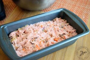 Step three is to transfer the meat to your greased loaf pan and bake.