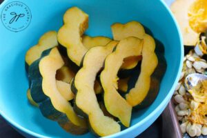 Step four of this Roasted Acorn Squash recipe is to oil the pieces of squash in whatever way you see fit.