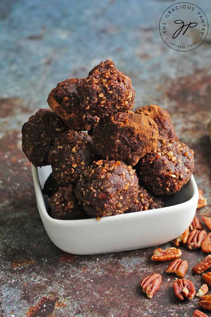 Rum balls piled high in a white bowl.