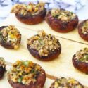 Stuffed Mushrooms sit on a serving tray, ready to serve to guests.