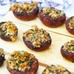 Stuffed Mushrooms sit on a serving tray, ready to serve to guests.