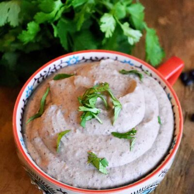 An overhead view looking down at this mug full of Black Bean Hummus.