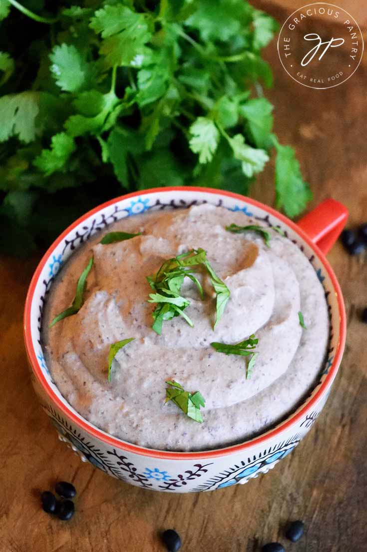 An overhead view looking down at this mug full of Black Bean Hummus.