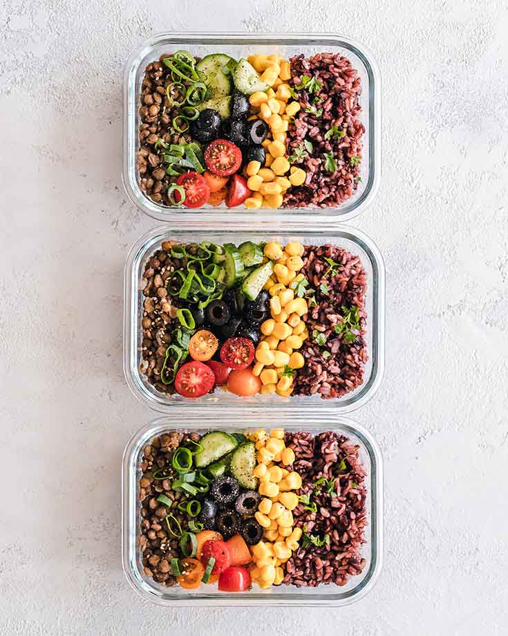 Three prepped meals sit in containers in a single row in this Meal Prep 101 guide.