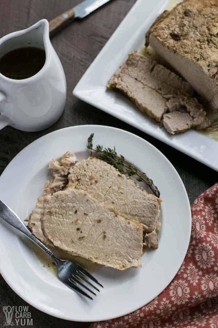 Slices of pressure Cooker Pork Loin Roast on a white plate.