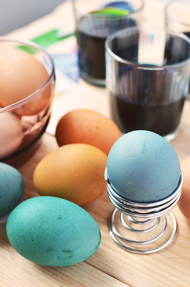 Colorful Easter eggs sit on a counter after just being dyed in this guide to making Homemade Egg Dye For Easter Eggs