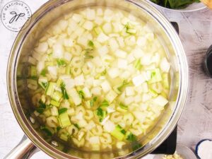 Step on of this Chicken Stir Fry Recipe is to sauté the white parts of the bok choy with the onions in the broth.