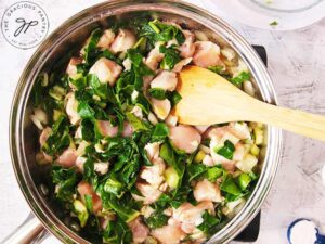 Step two is to add in the chicken and the green parts of the bok choy.