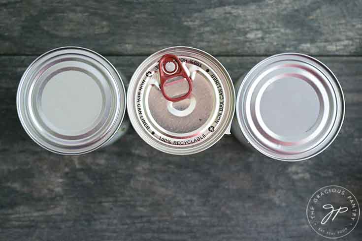 An overhead view of three cans standing in a row.