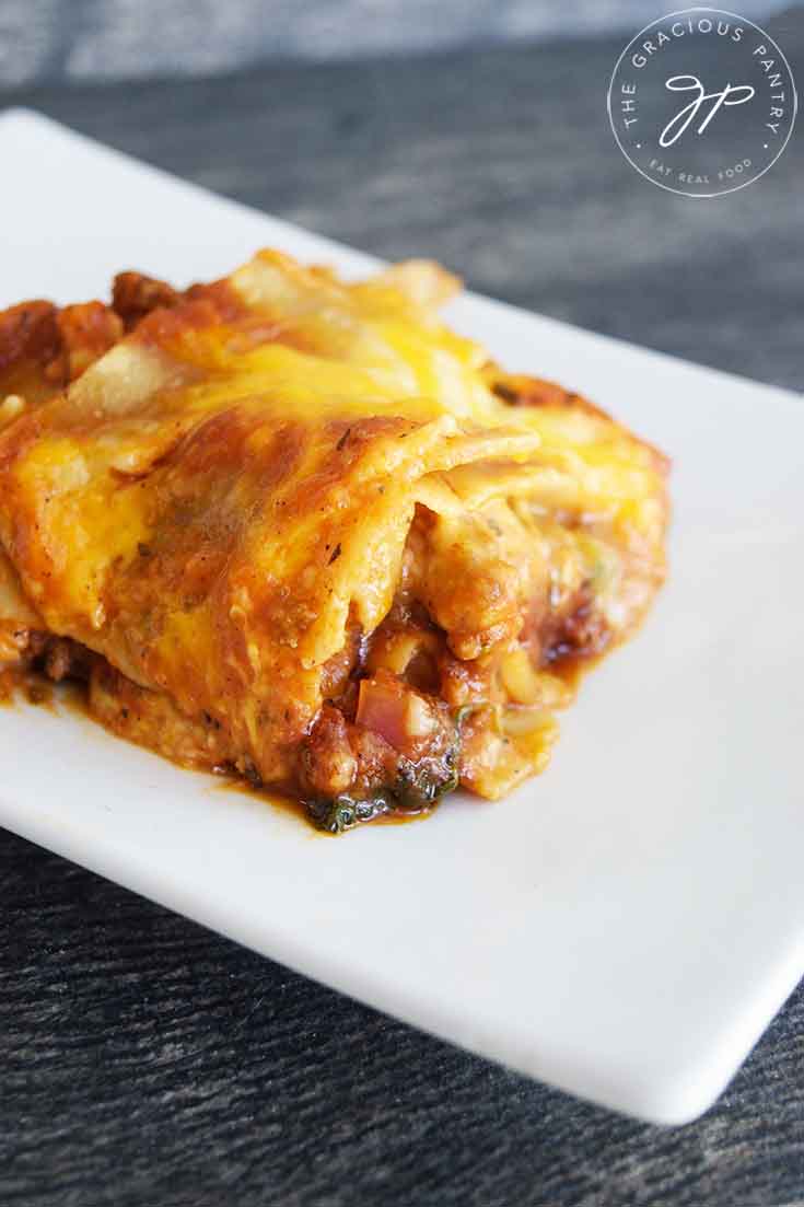 A side view of this Homemade Lasagna Recipe shows the melted cheese oozing over the other ingredients in this single slice.