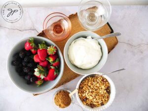 Berry Trifle bar setup from overhead. All ingredients are in separate bowls.